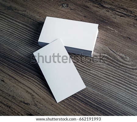 Photo of blank white business cards on wooden background. For design portfolios. Blank template for branding identity.