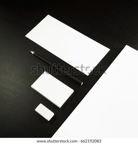 Photo of blank stationery set on black wooden table background. Corporate identity template for ID. Responsive design mockup.