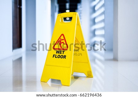 Sign showing warning of  wet floor on wet  floor 