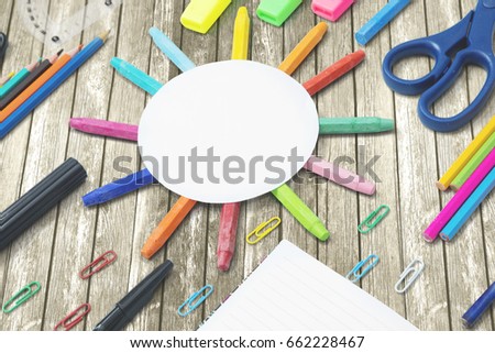 Picture of multicolored stationery with empty round paper on the wooden table 