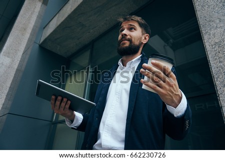 Surprised businessman, businessman holding a glass of coffee, businessman with phone.