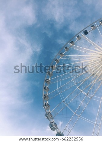 retro ferris wheel and blue sky background at an amusement park.