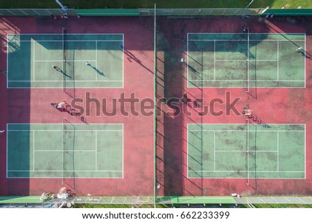 Top view public tennis court with player. Aerial view from flying drone