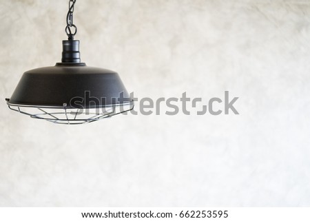 Hanging lamp, black vintage on concrete wall.Industrial pendant lamps against rough wall, loft style.Vintage Interiors Concept.
