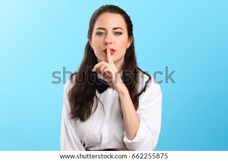 Young beautiful waitress making silence gesture on colorful background