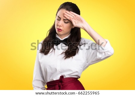 Young beautiful waitress with fever on colorful background