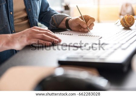 Man is writing necessary information
