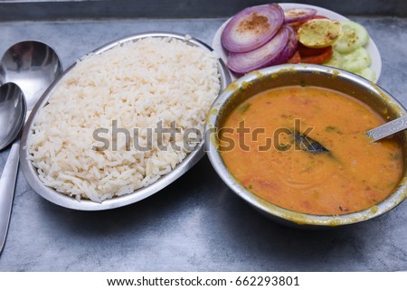 White or Basmati rice and Tadka dal fry is a North Indian hot and spicy curry dish Jaipur, Rajasthan India. Side dish for missi roti, paratha, parantha.
