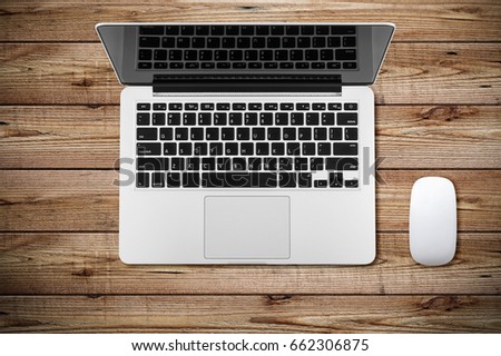 Modern workplace with notebook and mouse copy space on wood background. Top view. Flat lay style.