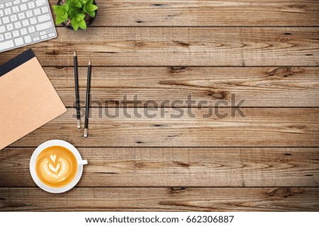 Modern workplace with notebook, smartphone, pencil and tree copy space on wood background. Top view. Flat lay style.