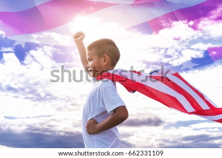Happy kid with American flag in standing in the summer sunshine. USA celebrate 4th of July- Independence Day. Patriotic holiday.