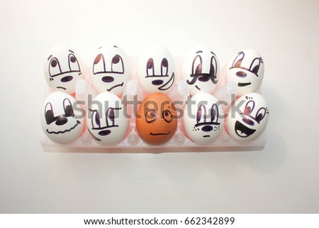 Concept of racial discrimination. White and black. Eggs with painted face. on a white background. Photo for your design