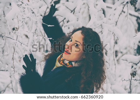 Beautiful portrait of a girl in a fur coat in the winter