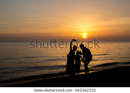 Family photo by the sea, sunset