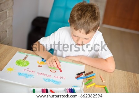 Child drawing and greeting card for his father on Father's Day