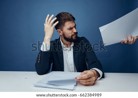 Businessman is surprised, businessman with documents, businessman is working on blue background