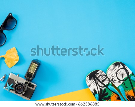 Summer Background, Summer holiday concept, Travel Concept with Untidy props are Sunscreen, Glasses, Camera, sea animal and hat on blue and yellow background.