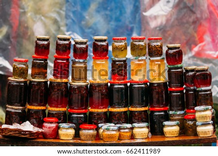 Various Jars With Sweet Tasty Yummy Jams Stading In Rows. Jam Made From Walnuts, Pine Cones, Walnuts, Honey, Pine Pollen. Traditional Healthy Cuisine