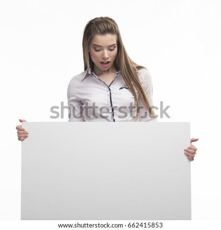 Young surprised woman portrait of a confident businesswoman showing presentation, pointing paper placard background. Ideal for banners, registration forms, presentation, landings, presenting concept.