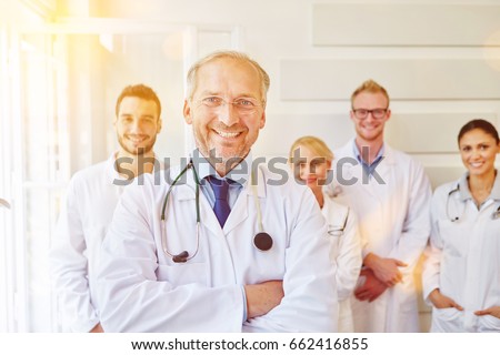 Chief physician and his successful team at hospital Royalty-Free Stock Photo #662416855