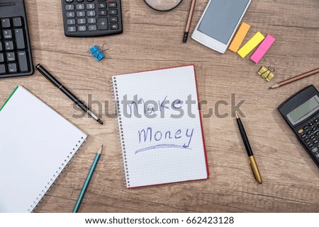 text Make Money on notepad with smartphone  keyboard, pen, calculator - at office