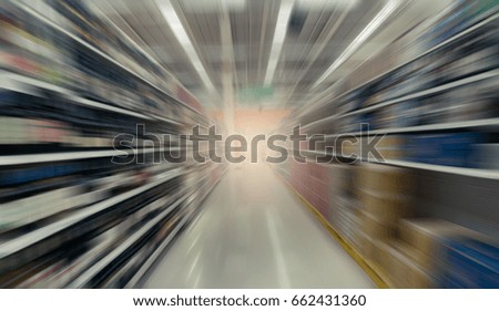 Abstract motion blurred image of supermarket aisle for background usage