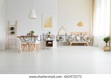 Big, white loft space with stylish wooden furniture Royalty-Free Stock Photo #662472571