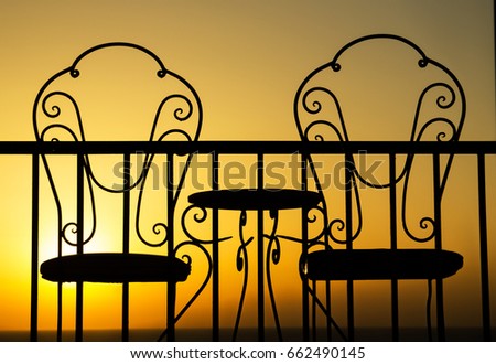 a nice Silhouette of chairs at sunset