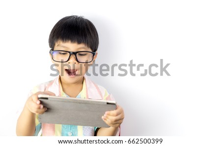 Nerdy Asian boy is surprising on what on the tablet