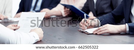 Member of management making notes of candidate's CV during interview