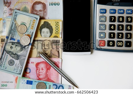banknote many currency, yen-Japan,dollar-USA,yuan-China, euro-EU,won-South Korea with smart phone, calculator and pen on white table.image for background ,wallpaper and copy space.