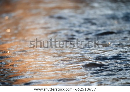Texture of water with small waves in a creek Royalty-Free Stock Photo #662518639