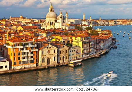 Venice. Top view of the Dorsoduro district, Cathedral of Santa Maria della Salute, embankment Zattere and Spirito Santo water bus stop in the rays of the setting sun Royalty-Free Stock Photo #662524786