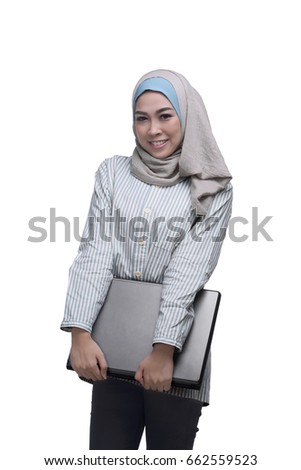 Beautiful asian muslim woman holding laptop isolated over white background