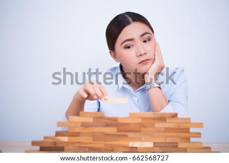 Asian woman planning build a tower puzzle