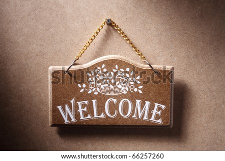 Welcome sign hung on background.