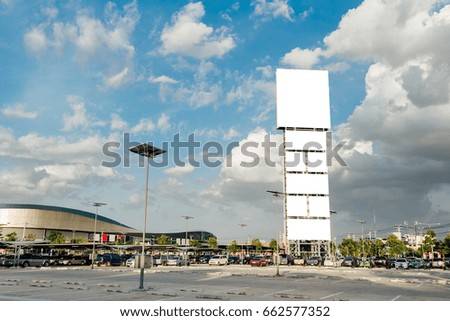 Blank big billboard blue sky background at parking lot,for your advertising,put your own text here,isolate white on board