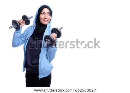 healthy Asian Muslim woman with hijab doing exercise Royalty-Free Stock Photo #662588029