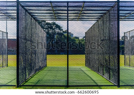 A cricket practice net on green grass in Melbourne, Victoria, Australia Royalty-Free Stock Photo #662600695