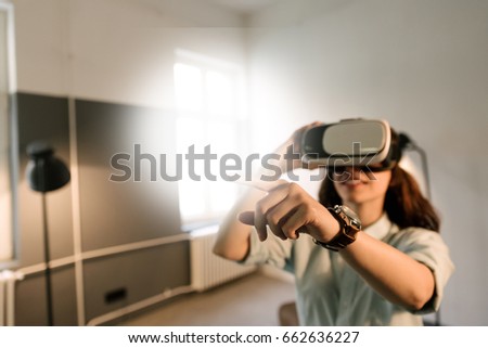 Girl having fun while using virtual reality headset
