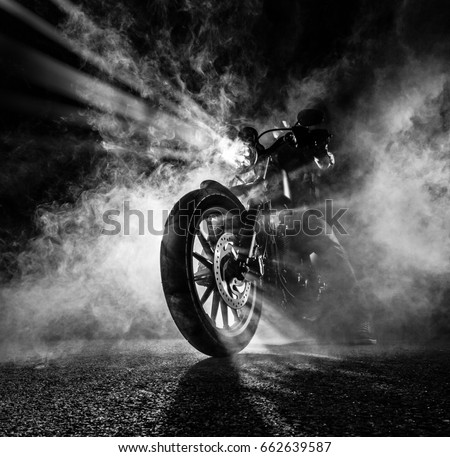 High power motorcycle chopper at night. Smoke on background. Royalty-Free Stock Photo #662639587