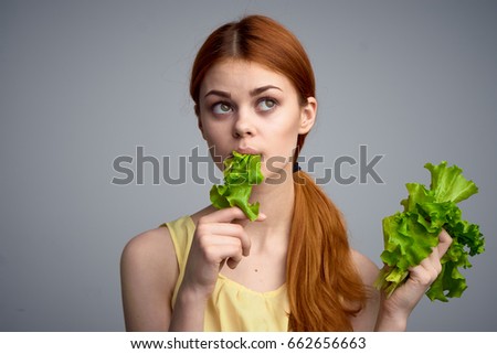 Woman eating lettuce, diet, healthy food, woman on gray background                               