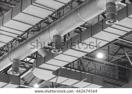 HVAC Duct Cleaning, Ventilation pipes in silver insulation material hanging from the ceiling inside new building. Royalty-Free Stock Photo #662674564