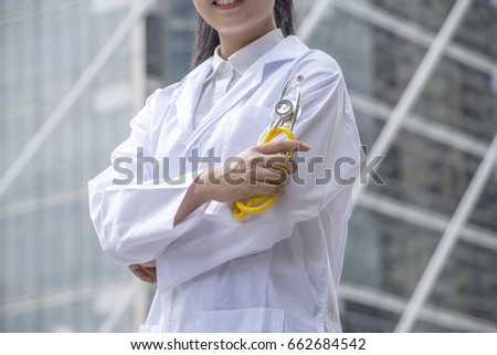 Attractive Asian female doctor in front Hospital