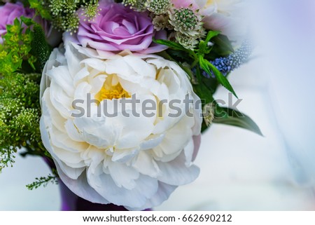 Bouquet of flowers from big peonies, pastel roses, scented peach stocks and wild, meadowy foliage on light background