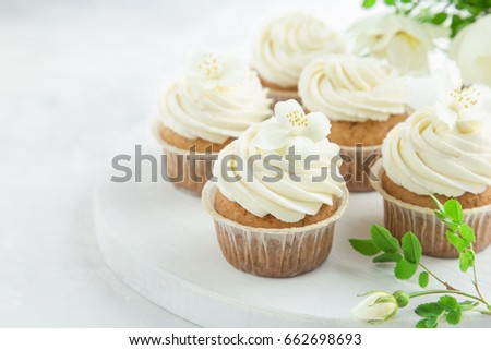vanilla cupcakes with cream cheese frosting,   white background, selective focus