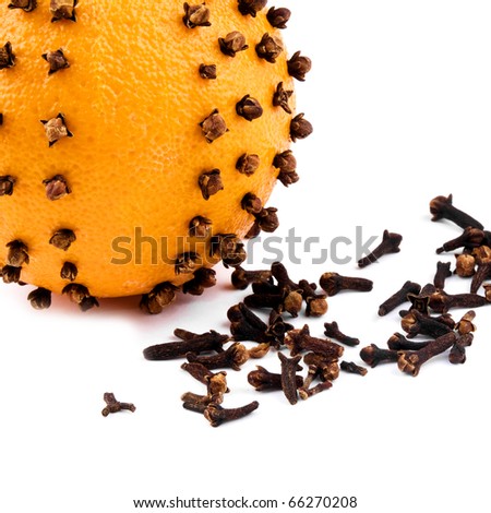 Closeup picture of aromatic Christmas orange with cloves on white background