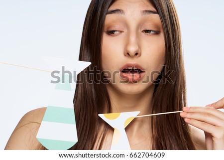 Woman with ties on a stick, woman on a light background                               