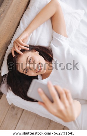 Beautiful girl taking picture of herself in morning