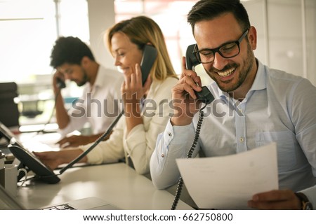 People in operations center  talking on Landline phone. Operators in the office.   Royalty-Free Stock Photo #662750800